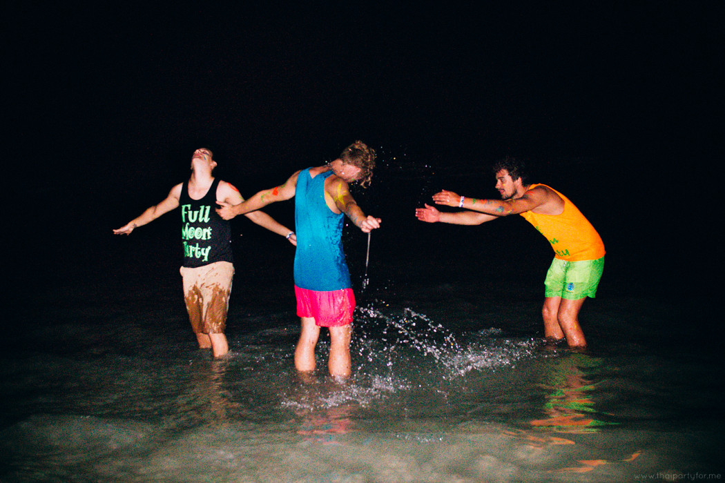 Guys splashing in the sea on Full Moon Party