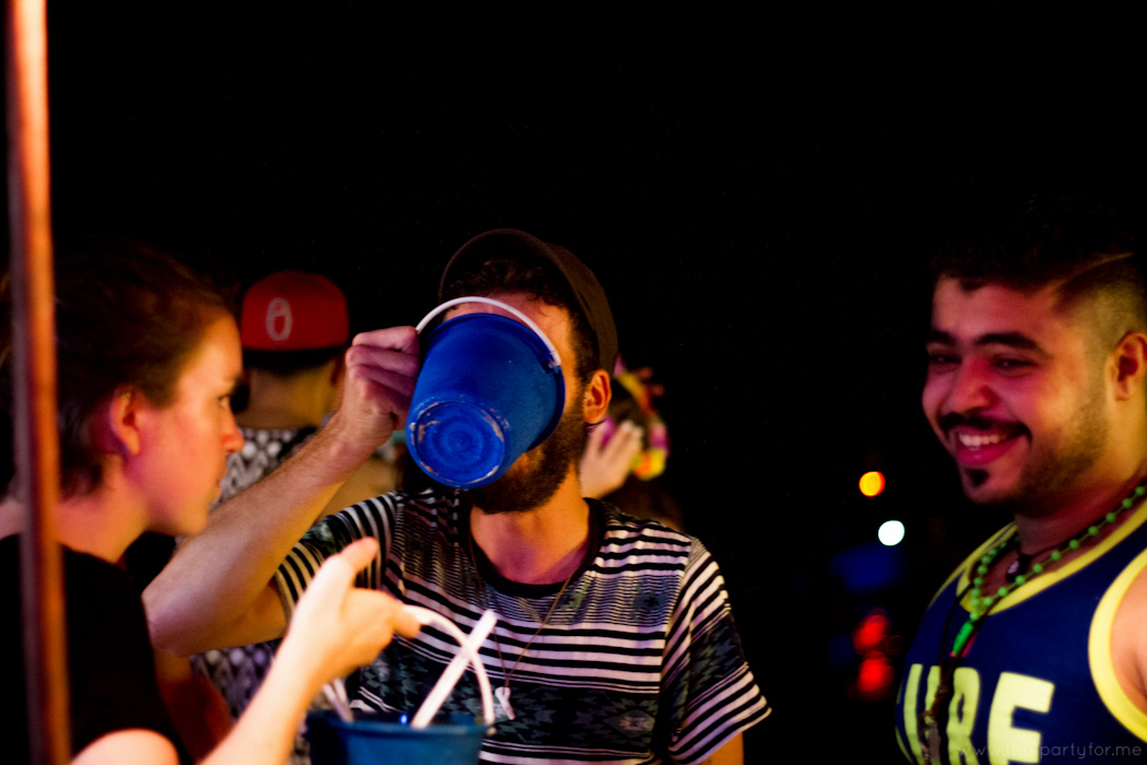Full Moon Party 6 October 2014 Photo 8. Man drinking from bucket.